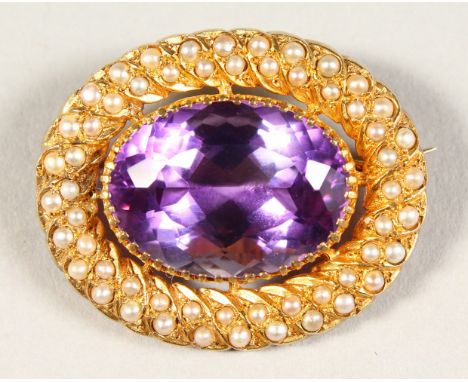 A GOOD 9CT GOLD, AMETHYST AND SEED PEARL OVAL BROOCH.