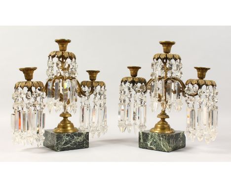 A GOOD PAIR OF 19TH CENTURY THREE-LIGHT CANDLESTICKS, all with prism drops, supported on square marble bases. 13.5ins high.