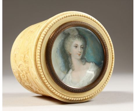 A GOOD CIRCULAR IVORY BOX, the lid with a portrait of a young lady. 2ins diameter.