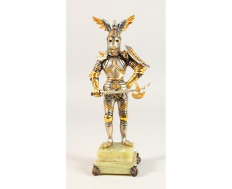 A LIMITED EDITION SILVERED AND GILT METAL MODEL OF A KNIGHT IN ARMOUR, on an onyx base. 10.5ins high.