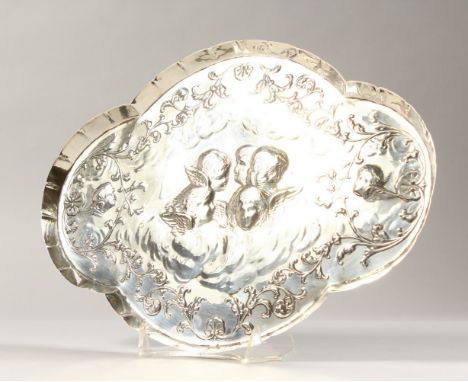 A VICTORIAN OVAL SHAPED TRINKET TRAY, repousse with angel head. 11.5ins long.  London 1900.