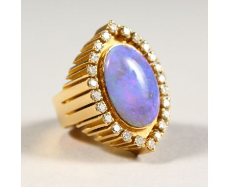 A VERY GOOD 18CT GOLD, FIRE OPAL AND DIAMOND RING.