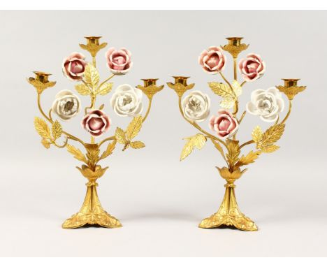 A PAIR OF GILT METAL THREE-LIGHT CANDLESTICKS, with porcelain roses. 14ins high.