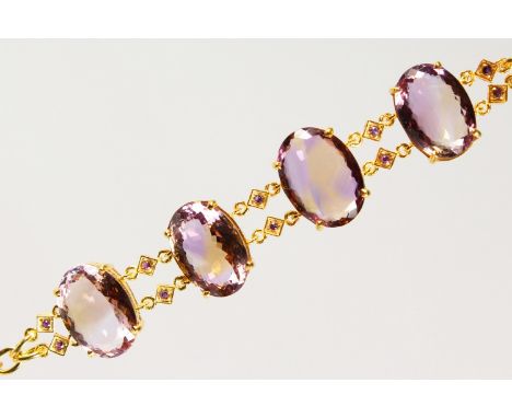 A SILVER GILT BRACELET, set with four large cut amethyst stones.