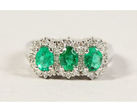 A GOOD 18CT WHITE GOLD FIVE STONE EMERALD AND DIAMOND RING.