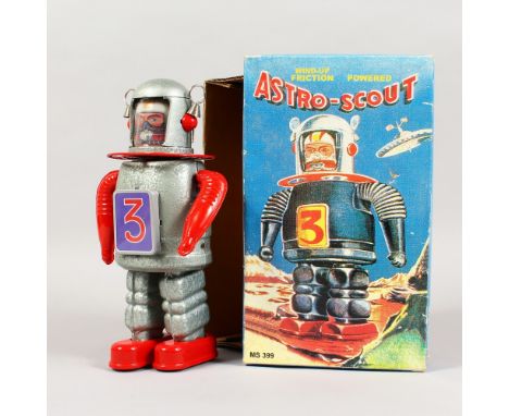 AN ASTRO SCOUT CLOCKWORK ROBOT, boxed. 9ins high.