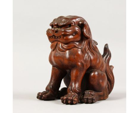 A CERAMIC BRONZED CHINESE DOG. 7ins high.