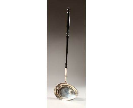 A SWEDISH SILVER PUNCH LADLE, with turned wood handle. 16ins long.