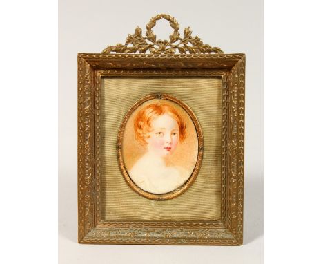 PORTRAIT HEAD AND SHOULDERS OF A YOUNG CHILD in a gilt frame. Oval.  2ins x 1.5ins.