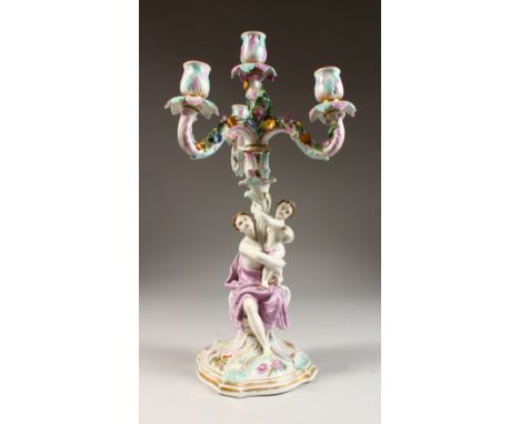 A MEISSEN DESIGN FOUR LIGHT CANDELABRA, with scrolling branches, the stem as a classical lady with cupid. 19ins high.