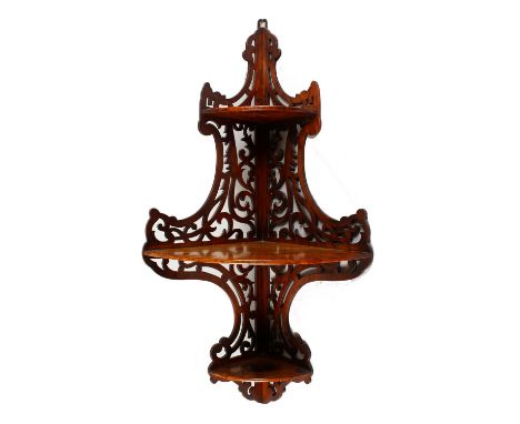 A 19TH CENTURY WALNUT CORNER WALL SHELF, with pierced decoration. 2ft 10ins high x 11ins deep.