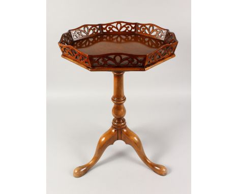 A GOOD CHIPPENDALE STYLE MAHOGANY TRIPOD TABLE, with galleried octagonal top, turned column, on three curving legs with pad f