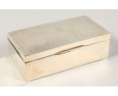 A RECTANGULAR ENGINE TURNED CIGARETTE BOX. 6.75ins long.