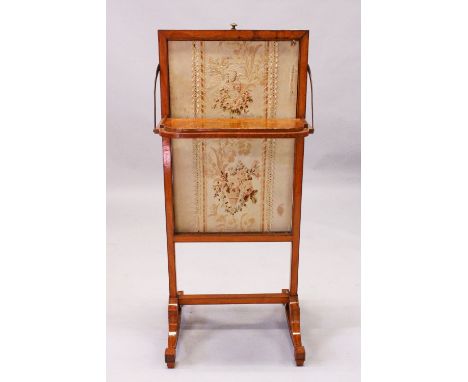 A 19TH CENTURY SATINWOOD FIRE SCREEN, with rising needlework panel, small shelf, on curving supports. 3ft 4ins high x 1ft 5in