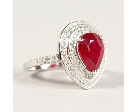 A GOOD 14K WHITE GOLD PEAR SHAPED RUBY AND DIAMOND RING, Ruby 3.23CTS.