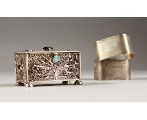 A PAIR OF ENGINE TURNED SERVIETTE RINGS and A FILIGREE BOX (3).