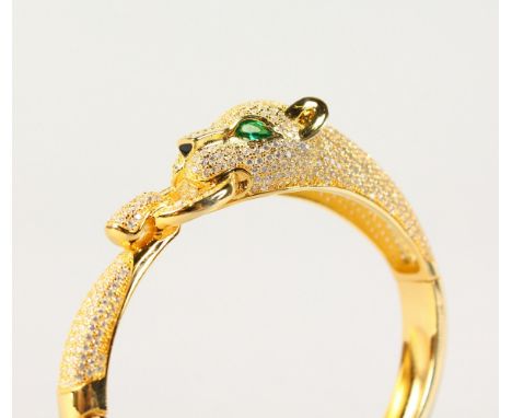 A SILVER AND GOLD PLATED PANTHER BANGLE.