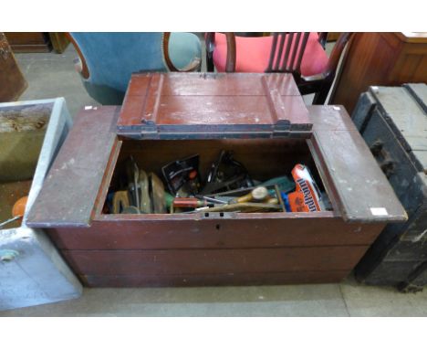 A Victorian stained pine tool chest with various tools 