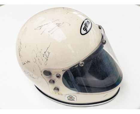 1970s original Griffin helmet signed by: Stirling Moss, Brian Redman, John Surtees, Tony Brooks, Danny Sullivan, Bobby Rahal,