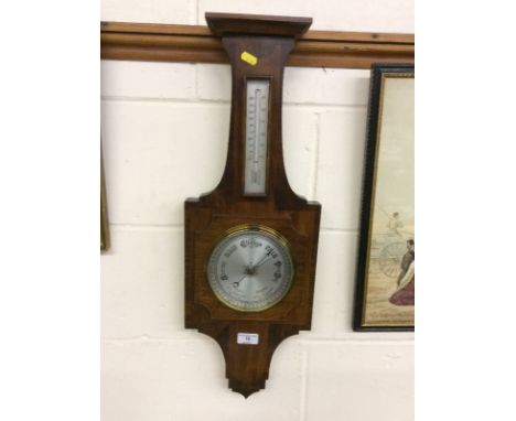 An Art Deco mahogany and walnut cross banded barometer