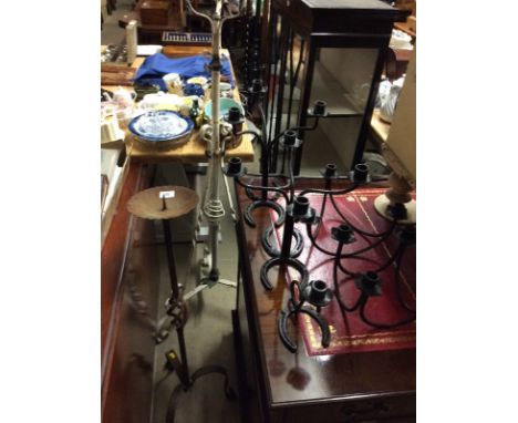 A quantity of various metalware to include candle stands, candlesticks, an oil lamp stand etc.