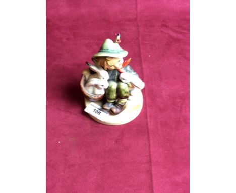 A Goebel figure in the form of a child with rabbits