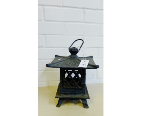 A black iron lantern style candle holder, 24cm high
