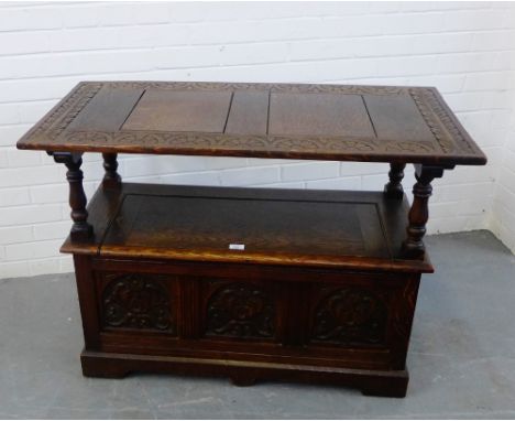 An oak Monk's bench, with foliate carving to the panels,  76 x 92cm, together with an oak mirror,(2) 