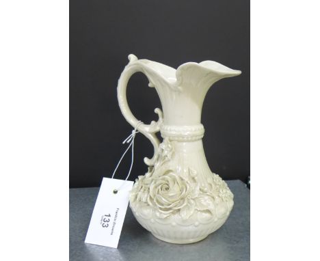 A Belleek porcelain floral encrusted ewer, with early black printed back stamp, 19cm high