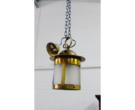 A brass hall lantern with opaque glass shade