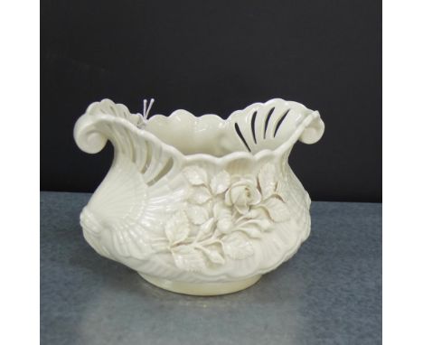 A Belleek porcelain floral encrusted planter, with early black back stamp, 10cm high