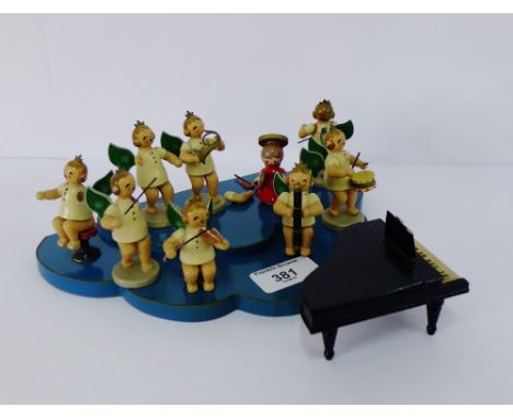 A vintage wooden painted Angel orchestra on a blue cloud shaped base, (11)