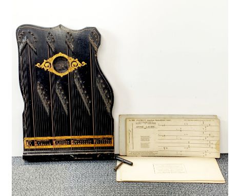 An early 20th century American harp-zither with instructions, H. 52cm.