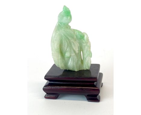 A small Chinese carved jade figure of a bird sitting on a branch, H. 6.5cm, With later stand.