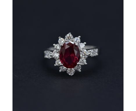 A 925 silver cluster ring set with an oval cut synthetic ruby and white stones, (P).