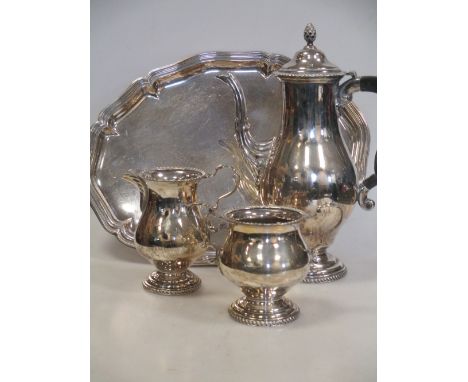A silver hot water pot, with pineapple finial and gadrooned border, Birmingham, 1947, together with a matching milk jug, a tw