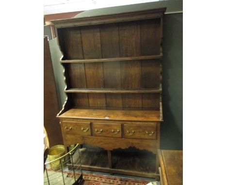 An 18th century oak dresser with enclosed shelf back  