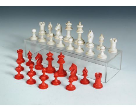 A red and white bone Staunton chess set, the pieces of typical shape, the kings 6.5cm (2.5 in) high  One arm of the cross at 