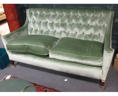 A green velvet upholstered button back two seater settee  