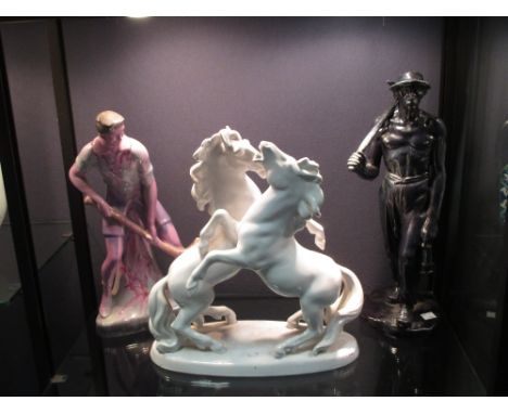 A white glazed ceramic Keramos figure group of rearing horses, together with an Art Deco style ceramic figure of a hockey pla
