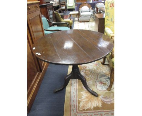 A George III oak tripod table, 83cm diameter  