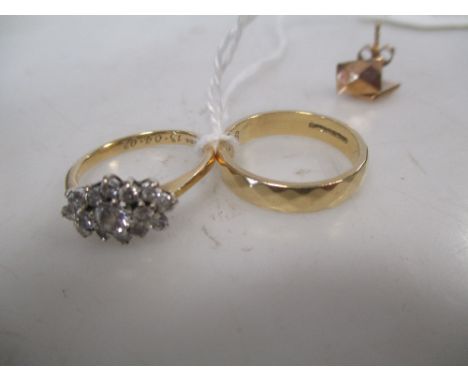 An 18ct diamond cluster ring, the round brilliant cut diamonds totalling approx. 0.16cts, set in white metal to a yellow meta