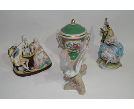 Group of ceramic figures including bird model and Continental porcelain vase and cover decorated with flowers on a green grou