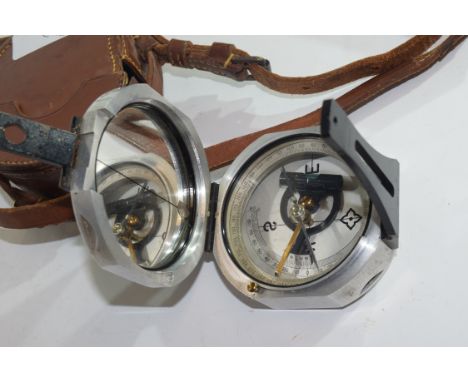 E R Watts, London, metal cased bearing compass in fitted leather case, compass approx 7.5cm wide