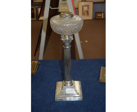 Late 19th century oil lamp, clear glass font, raised on a silver plated Corinthian column and a stepped square base, 49cm hig