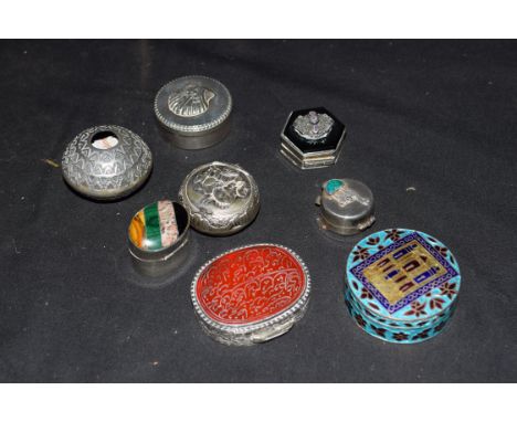 Collection of sterling silver and white metal pill boxes to include a Jordanian enamelled example, one with clam shell decora