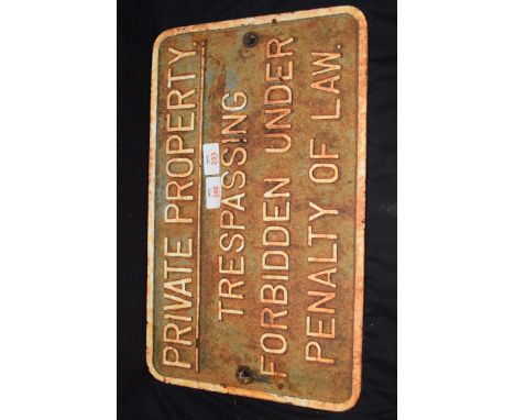 Vintage cast iron plaque marked "Private property.  Trespassing forbidden under penalty of law", 45cm wide