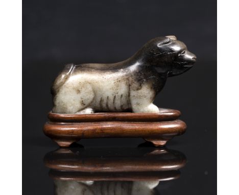 A Chinese black and grey jade carving  late Ming of a dog like mythological beast, 7.5cm x 4cm with hardwood stand From a pri