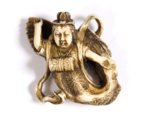 A Japanese ivory netsuke of an Apsara (Tennin) late Meiji depicted in flight and a drum at chest height, robes engraved kiku 