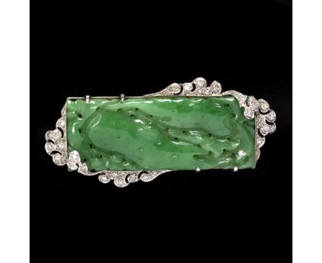 A Chinese jade and diamond panel brooch the rectangular jade panel pierced and carved with two cat fish within a scrolled fol